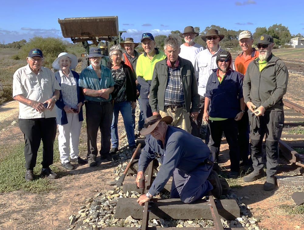Golden spike nailed to track post image