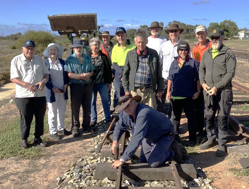 Golden spike nailed to track post image